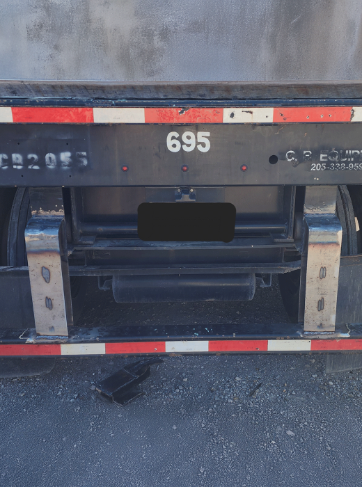 Rear view of a commercial truck with custom welded steel brackets installed on the bumper.